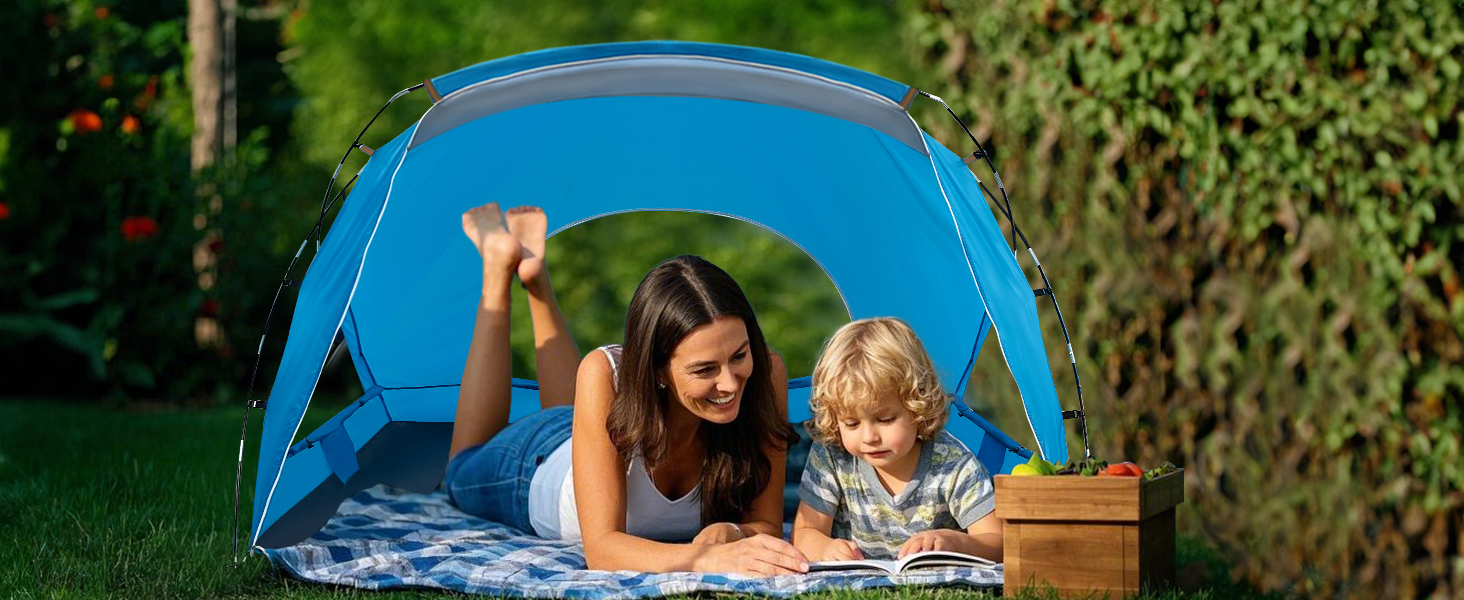 Mother and child reading in tent