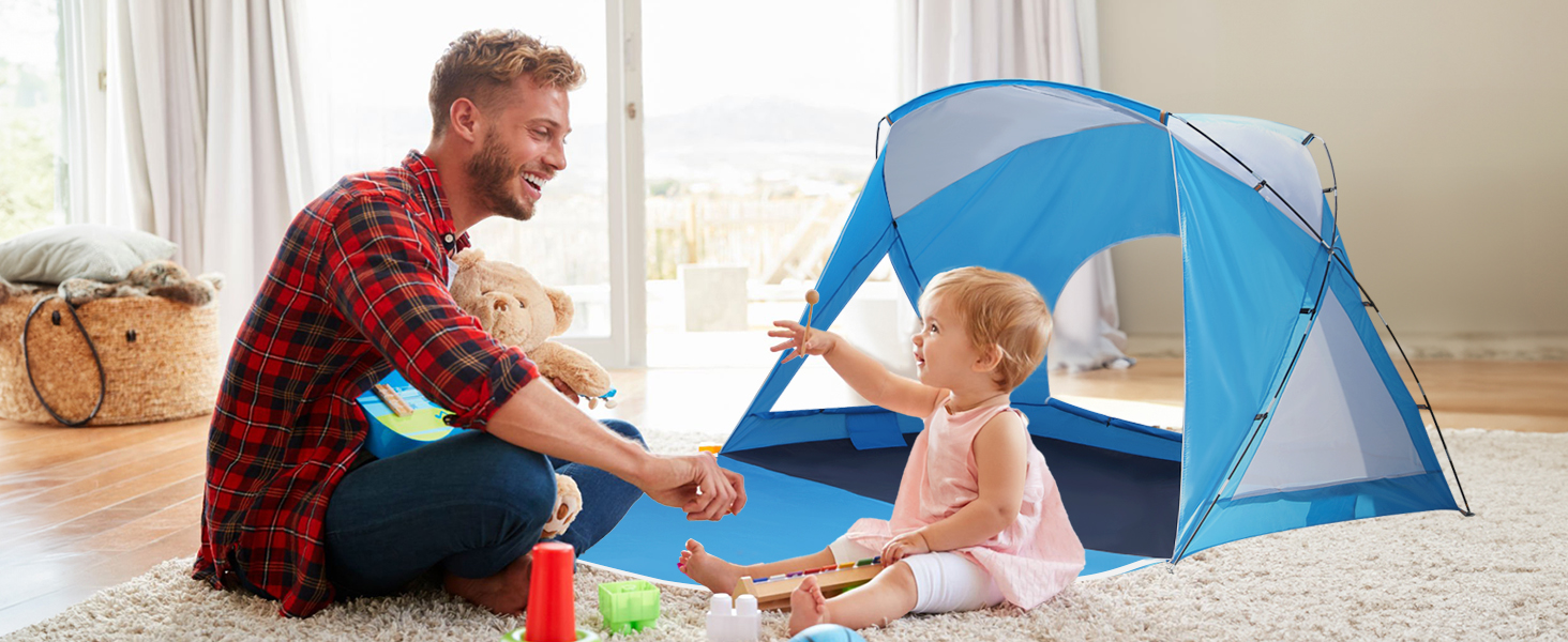 Dad and daughter playing next to a tent indoors