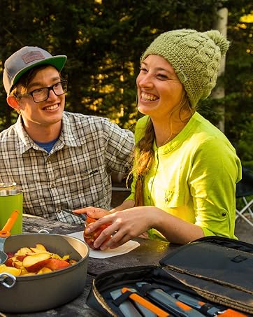 People enjoy a picnic outdoors with GSI tableware.
